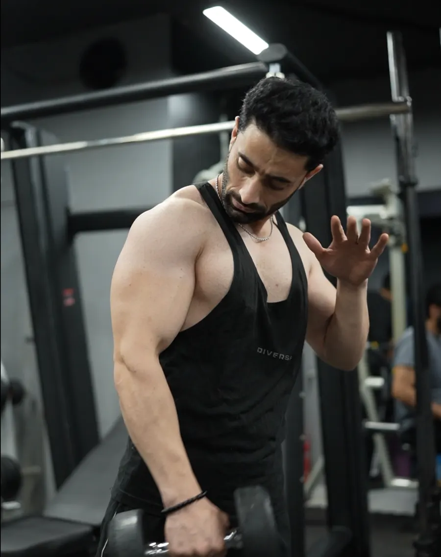 Member doing a dumbbell curl at Fitnation Gym, DHA Phase 5